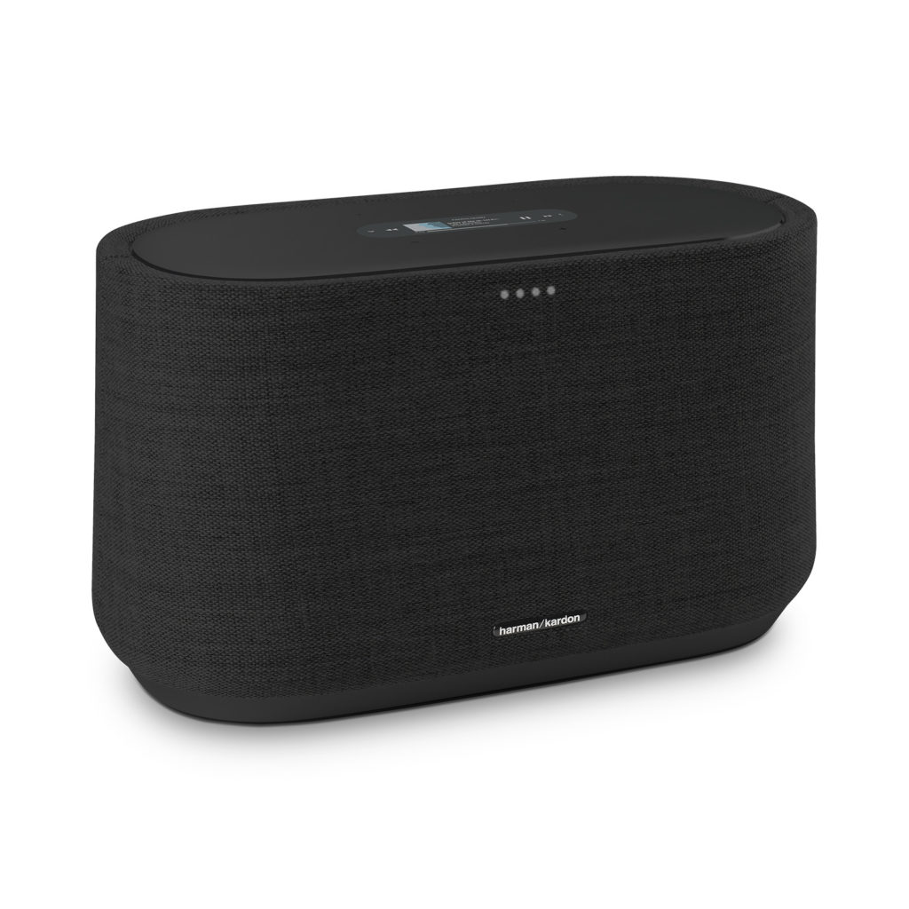 A sleek Harman Kardon Citation 300 wireless speaker sitting on a modern wooden table.