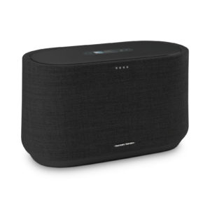 A sleek Harman Kardon Citation 300 wireless speaker sitting on a modern wooden table.